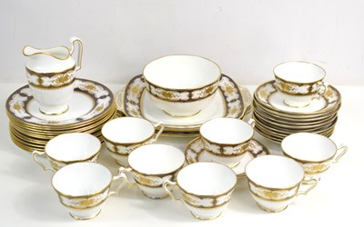 Lot 166 - A Crown Staffordshire part tea service in gold...