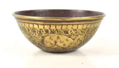 Lot 235 - An Islamic brass bowl embossed with animals...