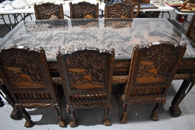 Lot 118 - A large carved Oriental hardwood dining table...