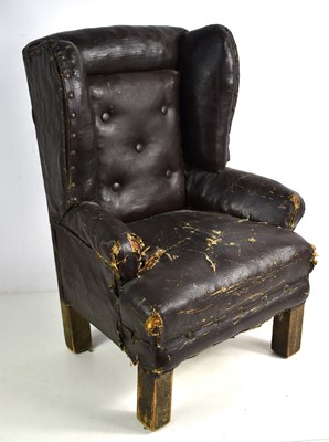 Lot 241 - An antique leather wingback armchair of small...