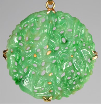 Lot 143 - A jade and possibly gold - unmarked - pendant...