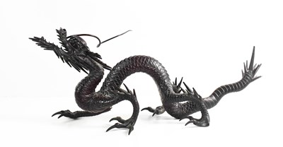 Lot 9 - A Qing Dynasty Chinese bronze dragon, of dark...