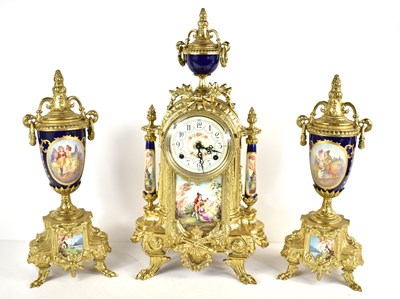 Lot 413 - A Franz Hermle clock garniture,  the clock...