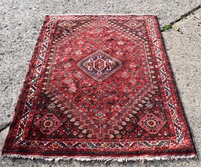 Lot 510 - A Persian Ghashgai rug, red ground with...