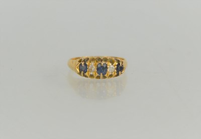 Lot 145 - An 18ct gold, diamond and sapphire ring, 2.77g,...