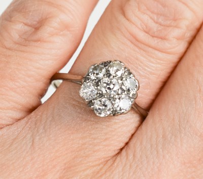 Lot 61 - An 18ct white gold, and diamond flowerhead...