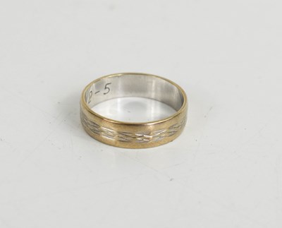 Lot 13 - A 9ct white gold wedding band, embossed with a...