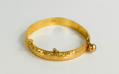 Lot 258 - A Chinese gold bangle, embossed with...