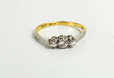 Lot 322 - An 18ct and diamond three stone ring, the...