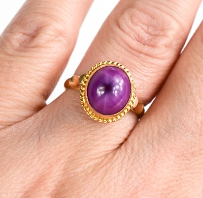 Lot 174 - An 18ct gold star ruby ring, the cabochon star...