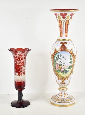 Lot 169 - A Bohemian ruby glass vase with an everted rim...