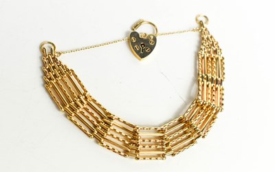 Lot 270 - A 9ct gold gate link bracelet, with a heart...