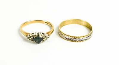 Lot 224 - A 9ct white and yellow gold ring, engraved...