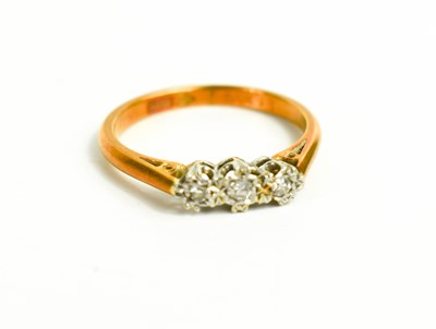 Lot 67 - An 18ct gold and three stone diamond ring,...