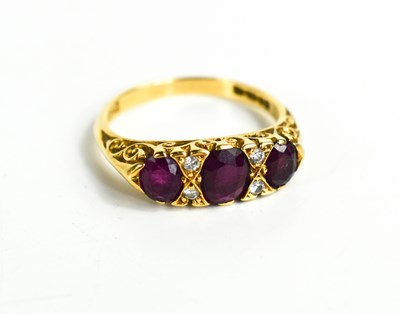 Lot 340 - An 18ct gold, ruby and diamond ring, the three...