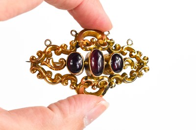 Lot 293 - A gold and garnet cabochon brooch, unmarked...