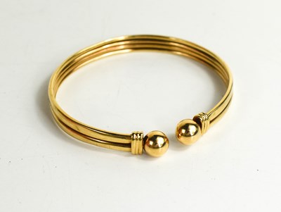 Lot 183 - A 9ct gold torc bracelet, with two reeded...