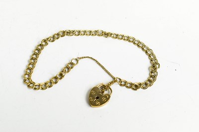 Lot 234 - A 9ct gold bracelet with a heart form clasp,...