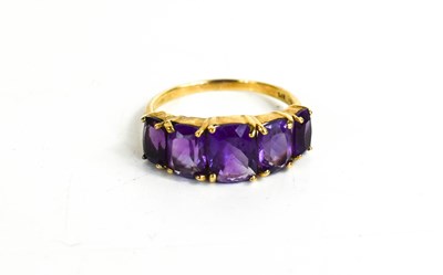 Lot 10 - A 9ct gold and amethyst ring, the five...