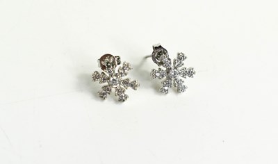 Lot 71 - A 9ct white gold and diamond snowflake form...