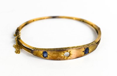 Lot 189 - A 9ct gold and sapphire bangle, the two oval...