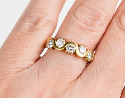 Lot 327 - An 18ct gold and diamond five stone ring, each...