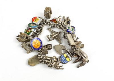 Lot 141 - A silver charm bracelet, with twenty six...