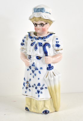 Lot 189 - A novelty porcelain figure of an elderly woman,...