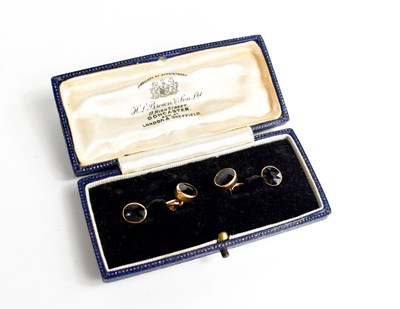 Lot 125 - A pair of 14ct gold and garnet set cufflinks,...