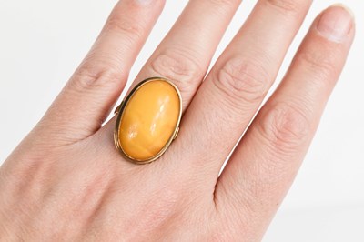 Lot 121 - An 8ct gold and butterscotch amber cabochon...