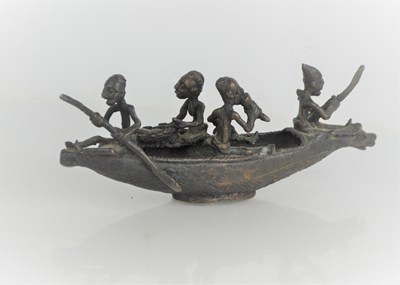 Lot 132 - An African bronze model of four figures in a boat