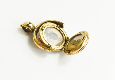 Lot 180 - A gold, agate and sardonyx locket, of swivel...