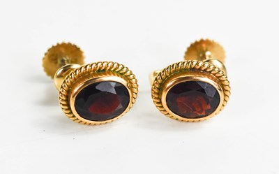 Lot 302 - A pair of 14ct gold and garnet earrings, the...