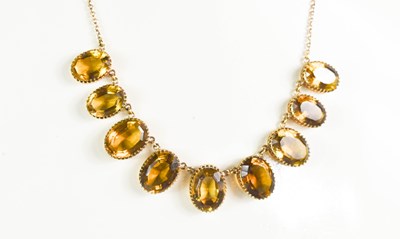 Lot 194 - A 9ct gold and citrine necklace, each oval cut...