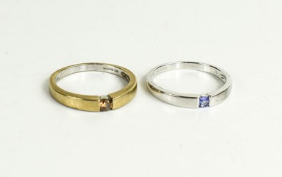 Lot 94 - Two 9ct gold solitaire rings, one set with an...