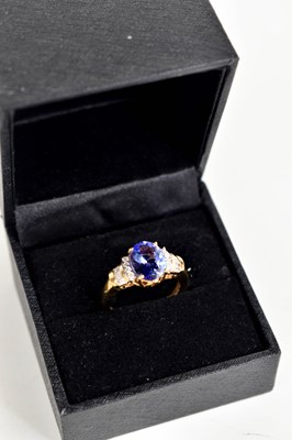 Lot 247 - An 18ct gold, diamond and tanzanite ring, the...