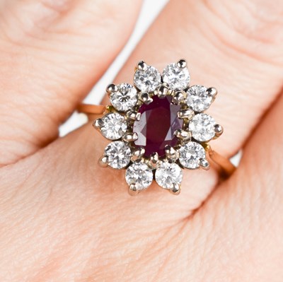 Lot 177 - An 18ct gold, ruby and diamond ring, the oval...