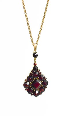 Lot 20 - A 9ct gold and garnet pendant necklace, with a...