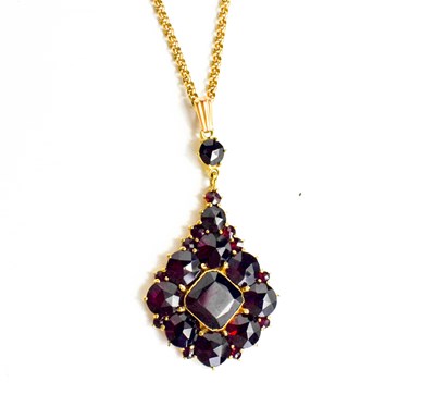 Lot 20 - A 9ct gold and garnet pendant necklace, with a...