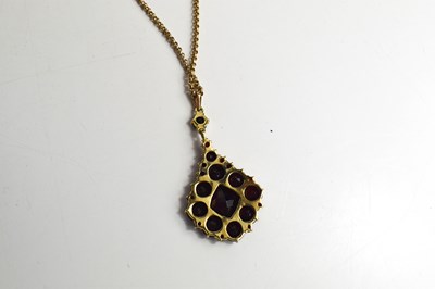 Lot 20 - A 9ct gold and garnet pendant necklace, with a...