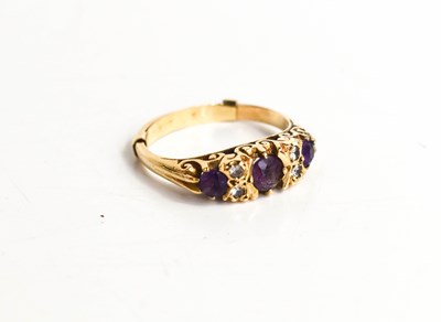 Lot 33 - A 9ct gold, amethyst and diamond ring, three...