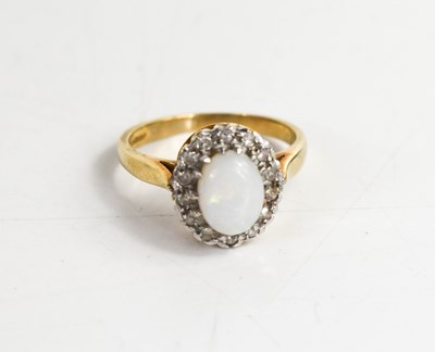 Lot 75 - A 9ct gold, opal and diamond ring, the oval...