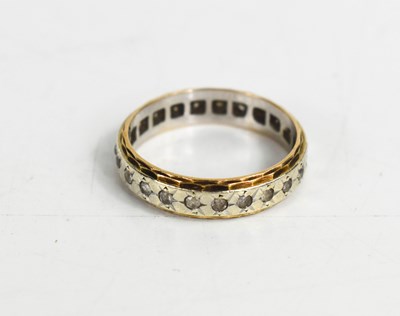 Lot 176 - A white and yellow gold ring, set with chip...