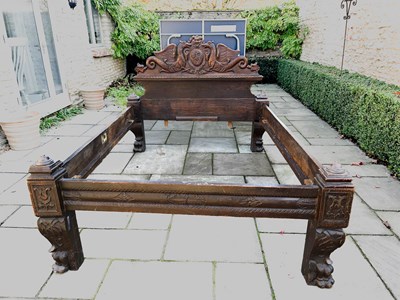 Lot 511 - An 18th century and later oak carved bed, the...