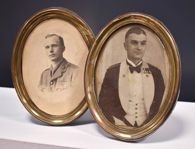 Lot 19 - A pair of silver oval form photograph frames,...