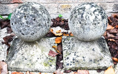 Lot 288 - A pair of stone gate post caps of ball form.