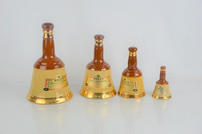 Lot 326 - A group of four Bells whisky decanters, full,...