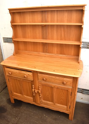 Lot 514 - An Ercol light elm sideboard and dresser, the...