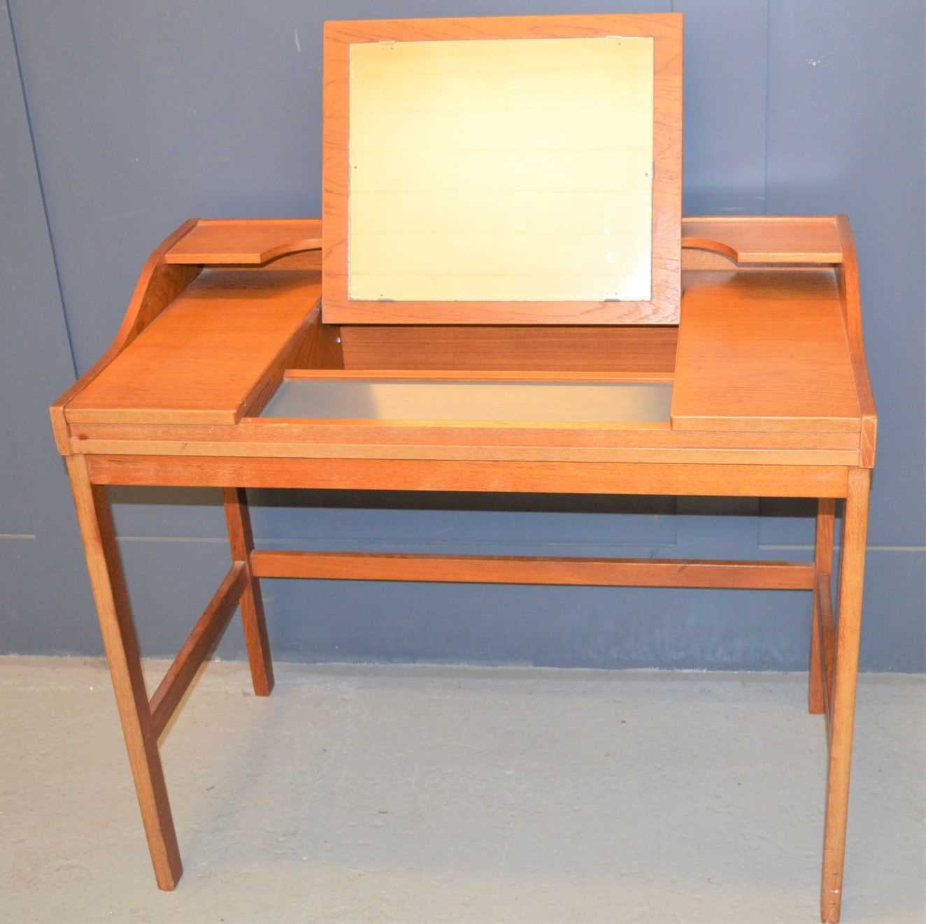 Lot 145 A midcentury teak dressing table with lift