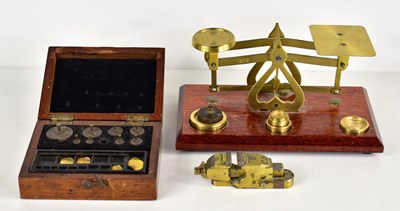 Lot 107 - A set of brass postal scales together with a...